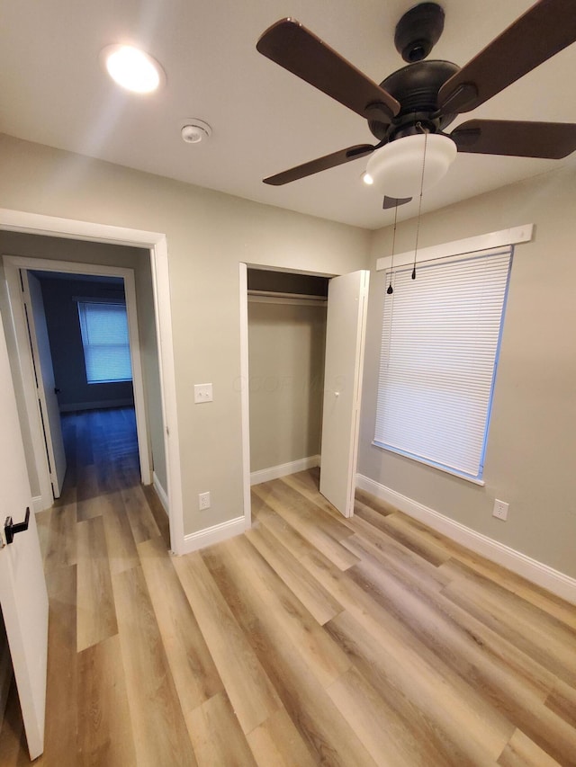 345 Dakota Ave, Columbus, OH 43223 - unfurnished bedroom with light wood-style floors, a closet, and a ceiling fan