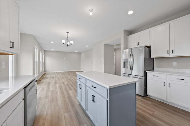 4462 Karbarda Way, Hilliard, OH 43026 - kitchen featuring stainless steel appliances, light wood-type flooring, white cabinetry, light countertops, and a chandelier