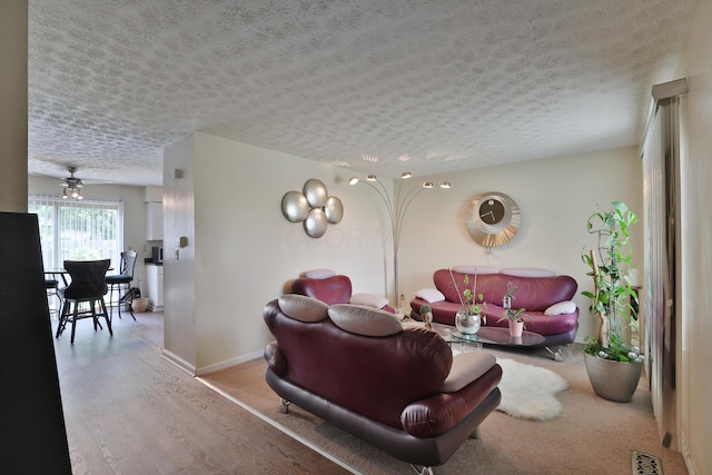 2214-2216 Pine Tree Ln, Reynoldsburg, OH 43068 - living room featuring a textured ceiling, wood finished floors, and a ceiling fan