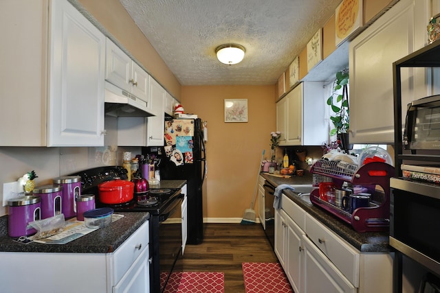2214-2216 Pine Tree Ln, Reynoldsburg, OH 43068 - kitchen featuring black electric range, under cabinet range hood, dark wood-style floors, white cabinetry, and dark countertops