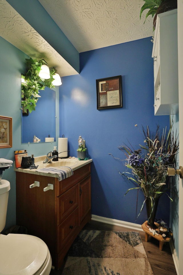 2214-2216 Pine Tree Ln, Reynoldsburg, OH 43068 - half bath with wood finished floors, vanity, and a textured ceiling