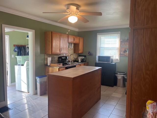 427 John St, Newark, OH 43055 - kitchen featuring independent washer and dryer, ceiling fan, tile countertops, light tile patterned flooring, and brown cabinets