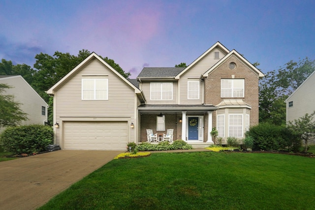 307 Timberland View Dr, Newark, OH 43055 - traditional home featuring covered porch, an attached garage, a front yard, and brick siding