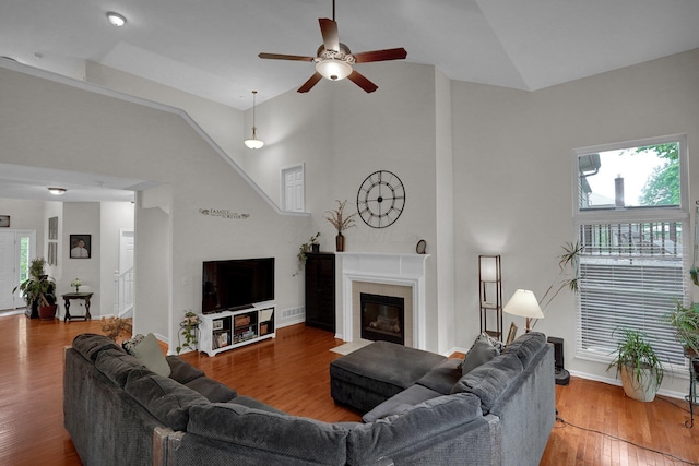 307 Timberland View Dr, Newark, OH 43055 - living room with a tile fireplace, ceiling fan, plenty of natural light, wood finished floors, and high vaulted ceiling