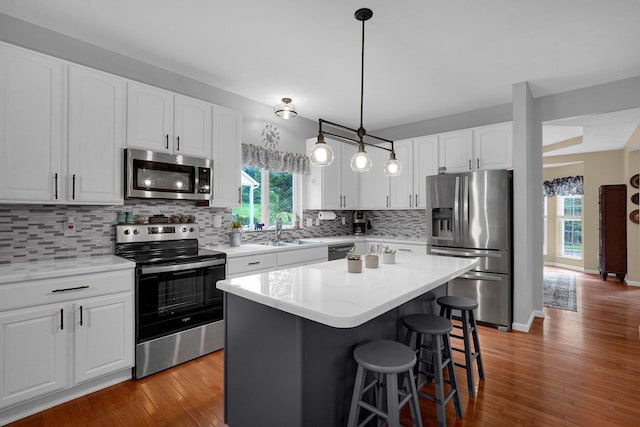 307 Timberland View Dr, Newark, OH 43055 - kitchen with appliances with stainless steel finishes, a kitchen bar, light wood-style floors, and decorative backsplash
