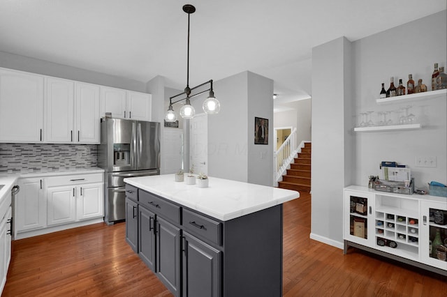 307 Timberland View Dr, Newark, OH 43055 - kitchen with stainless steel fridge with ice dispenser, white cabinetry, gray cabinetry, decorative backsplash, and wood finished floors