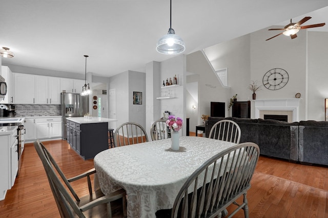307 Timberland View Dr, Newark, OH 43055 - dining area featuring ceiling fan, light wood finished floors, and a tile fireplace