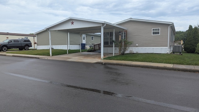 22 Birch Row Dr, Delaware, OH 43015 - manufactured / mobile home with a front lawn, an attached carport, and driveway