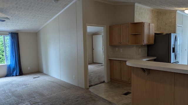 22 Birch Row Dr, Delaware, OH 43015 - kitchen featuring stainless steel fridge with ice dispenser, a textured ceiling, light countertops, crown molding, and light carpet