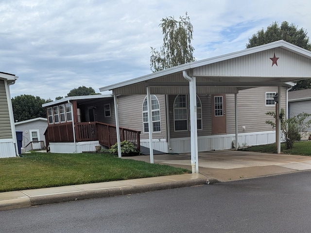 22 Birch Row Dr, Delaware, OH 43015 - manufactured / mobile home with a front yard, a carport, and concrete driveway
