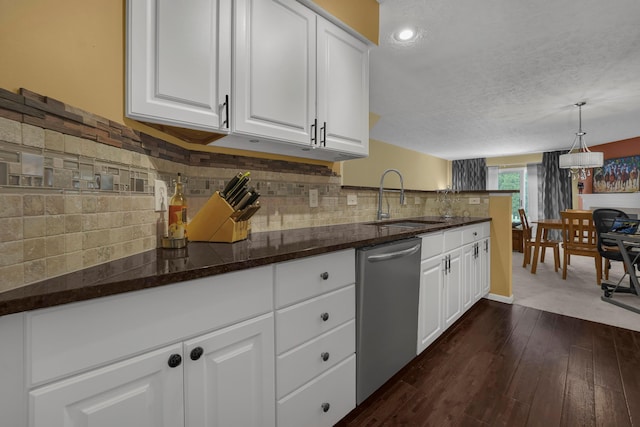 2184 Victoria Park Dr, Columbus, OH 43235 - kitchen featuring stainless steel dishwasher, white cabinetry, a textured ceiling, decorative backsplash, and a peninsula