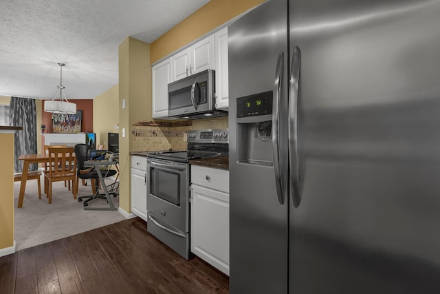 2184 Victoria Park Dr, Columbus, OH 43235 - kitchen with stainless steel appliances, dark countertops, white cabinets, a textured ceiling, and backsplash