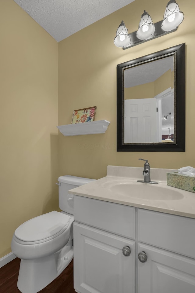 2184 Victoria Park Dr, Columbus, OH 43235 - bathroom with wood finished floors, vanity, and a textured ceiling