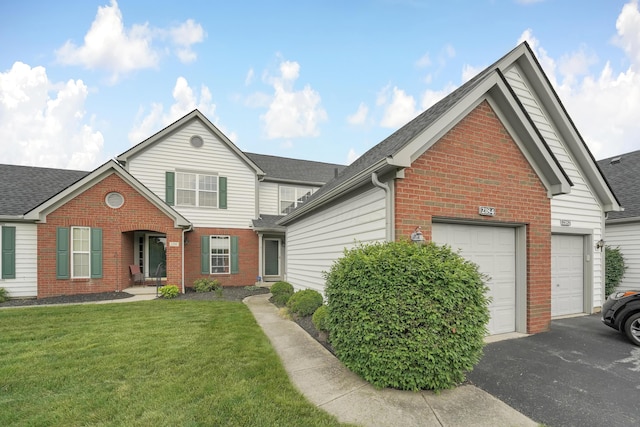 2184 Victoria Park Dr, Columbus, OH 43235 - traditional-style house with brick siding, an attached garage, a front lawn, and roof with shingles