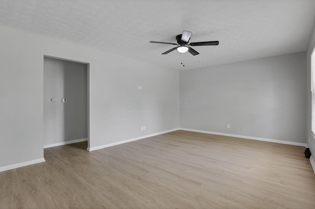 1615 Coronet Dr, Columbus, OH 43224 - empty room featuring light wood-style floors, a ceiling fan, and a textured ceiling