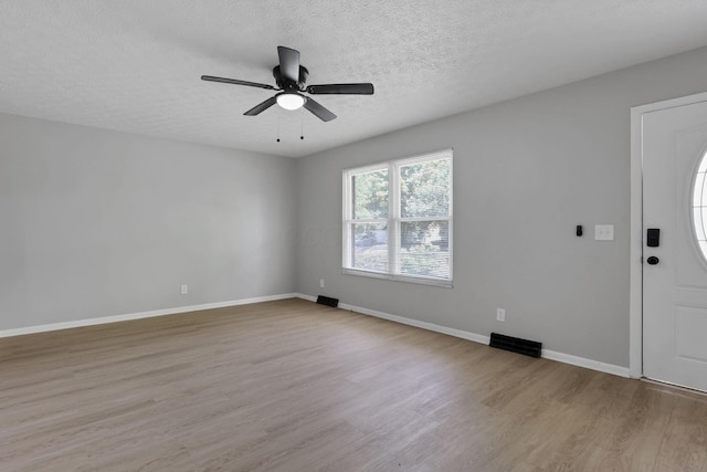 1615 Coronet Dr, Columbus, OH 43224 - unfurnished room with wood finished floors, ceiling fan, and a textured ceiling