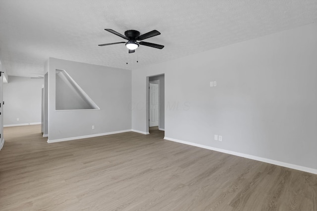 1615 Coronet Dr, Columbus, OH 43224 - empty room with wood finished floors, a ceiling fan, and a textured ceiling