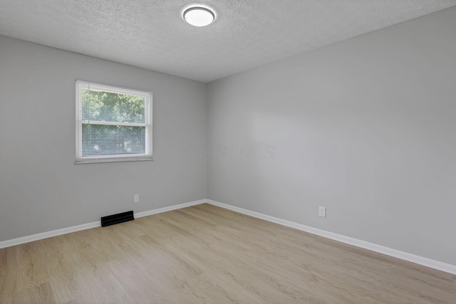 1615 Coronet Dr, Columbus, OH 43224 - spare room with wood finished floors and a textured ceiling