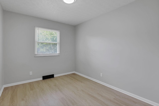 1615 Coronet Dr, Columbus, OH 43224 - spare room with wood finished floors and a textured ceiling