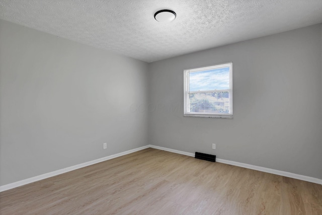 1615 Coronet Dr, Columbus, OH 43224 - spare room featuring wood finished floors and a textured ceiling