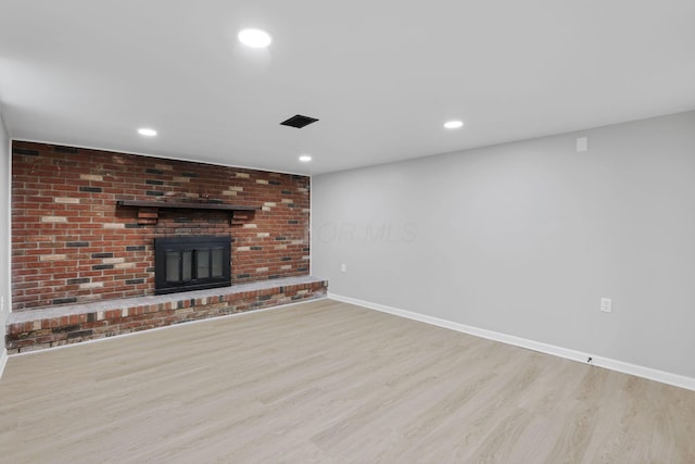 1615 Coronet Dr, Columbus, OH 43224 - unfurnished living room featuring wood finished floors, a brick fireplace, and recessed lighting