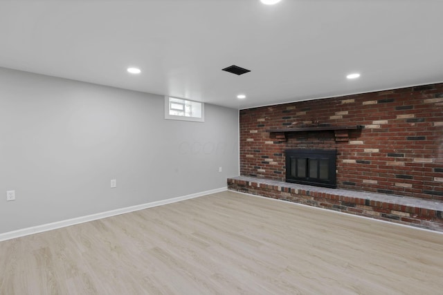 1615 Coronet Dr, Columbus, OH 43224 - unfurnished living room with wood finished floors, a brick fireplace, and recessed lighting