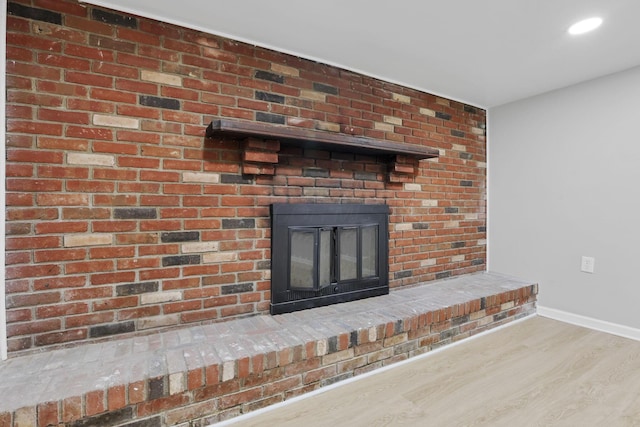 1615 Coronet Dr, Columbus, OH 43224 - detailed view of a brick fireplace, wood finished floors, and recessed lighting