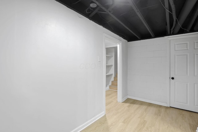1615 Coronet Dr, Columbus, OH 43224 - finished below grade area with light wood finished floors and concrete block wall