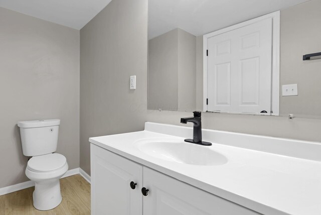 1615 Coronet Dr, Columbus, OH 43224 - half bathroom featuring vanity and wood finished floors