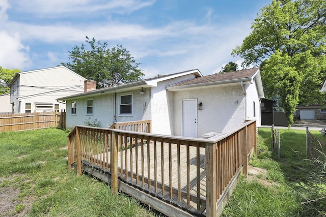 1615 Coronet Dr, Columbus, OH 43224 - back of property featuring stucco siding, a deck, and a chimney