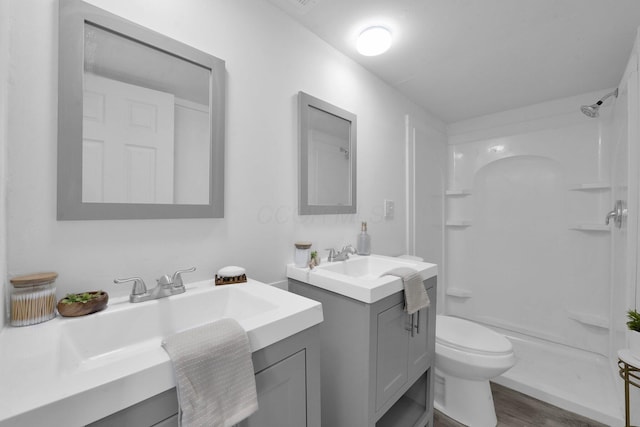 634 Columbus Ave Unit 1, Washington Court House, OH 43160 - full bathroom with two vanities, a shower, and wood finished floors