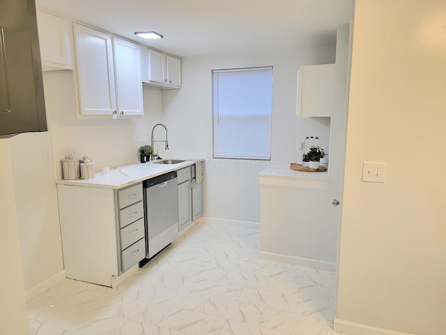 570 N Ohio Ave, Columbus, OH 43203 - kitchen featuring stainless steel dishwasher, light marble finish flooring, light countertops, white cabinets, and tasteful backsplash