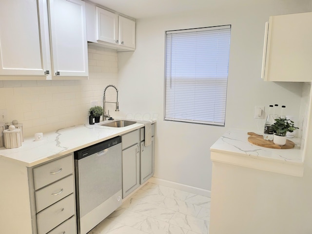 570 N Ohio Ave, Columbus, OH 43203 - kitchen featuring dishwasher, light stone counters, backsplash, and light marble finish flooring