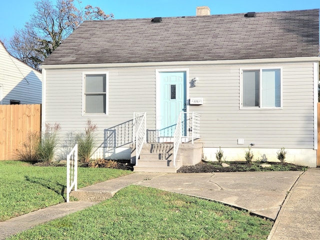 570 N Ohio Ave, Columbus, OH 43203 - cape cod house with a chimney, a shingled roof, and a patio