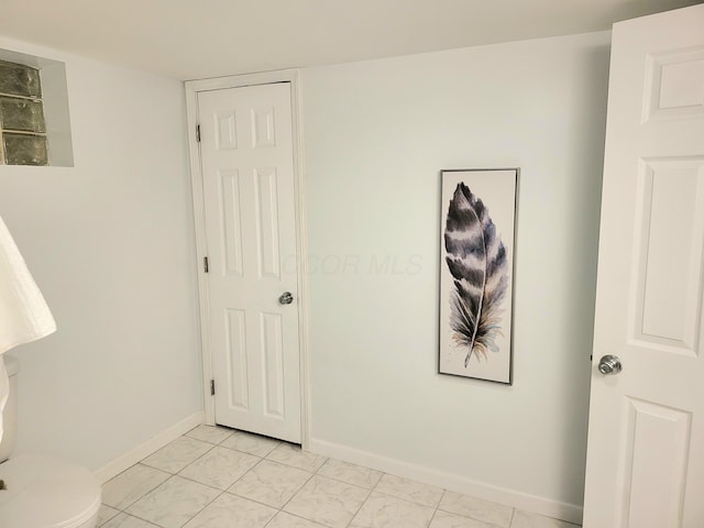 570 N Ohio Ave, Columbus, OH 43203 - unfurnished bedroom featuring light marble finish floors and baseboards