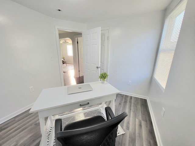 570 N Ohio Ave, Columbus, OH 43203 - home office with arched walkways, healthy amount of natural light, and wood finished floors
