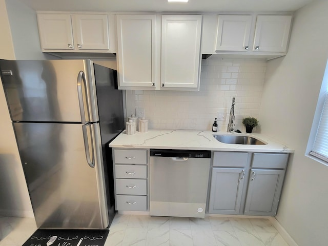 570 N Ohio Ave, Columbus, OH 43203 - kitchen with stainless steel appliances, light marble finish floors, gray cabinets, tasteful backsplash, and light stone counters