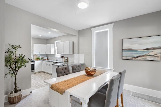 225 N Hague Ave, Columbus, OH 43204 - dining area with baseboards and light colored carpet