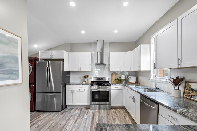 225 N Hague Ave, Columbus, OH 43204 - kitchen with wall chimney range hood, appliances with stainless steel finishes, white cabinetry, vaulted ceiling, and recessed lighting