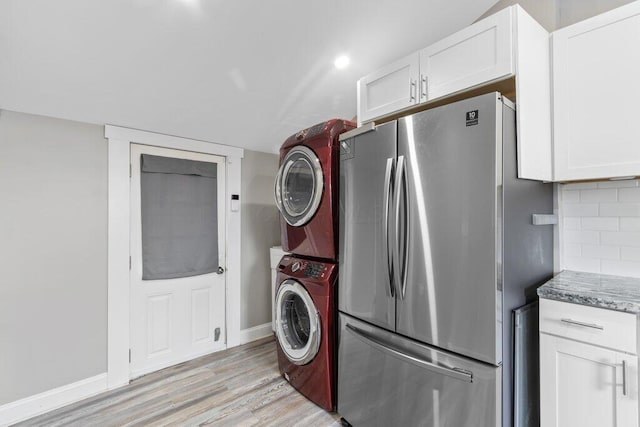 225 N Hague Ave, Columbus, OH 43204 - laundry room with stacked washer and clothes dryer and light wood finished floors