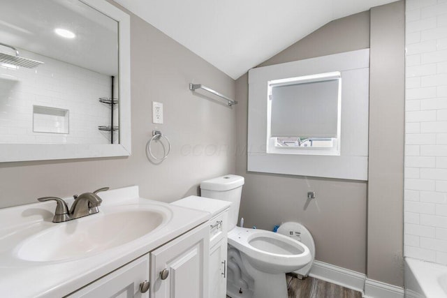 225 N Hague Ave, Columbus, OH 43204 - full bathroom featuring vanity, vaulted ceiling, wood finished floors, and shower / washtub combination