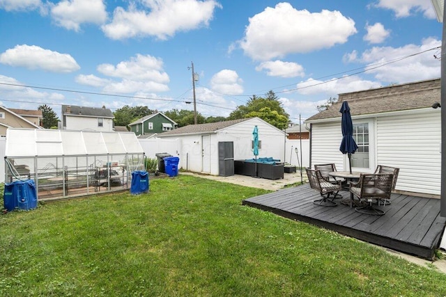 225 N Hague Ave, Columbus, OH 43204 - view of yard featuring a greenhouse, an outdoor structure, an outdoor living space, a wooden deck, and outdoor dining area