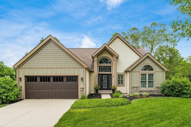 918 Dianthus Ct, Reynoldsburg, OH 43068 - view of front facade with board and batten siding, stone siding, a garage, a front lawn, and driveway