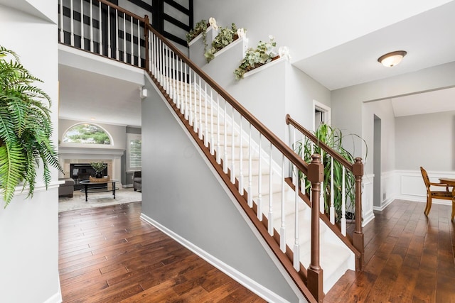 918 Dianthus Ct, Reynoldsburg, OH 43068 - stairway with hardwood / wood-style floors, a glass covered fireplace, and wainscoting