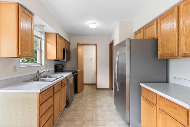 3299 Bellowind Dr, Reynoldsburg, OH 43068 - kitchen with stainless steel appliances, light countertops, a textured ceiling, and light floors