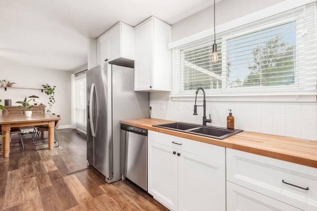 436 Darbyhurst Rd, Columbus, OH 43228 - kitchen with wood counters, appliances with stainless steel finishes, backsplash, dark wood finished floors, and white cabinets