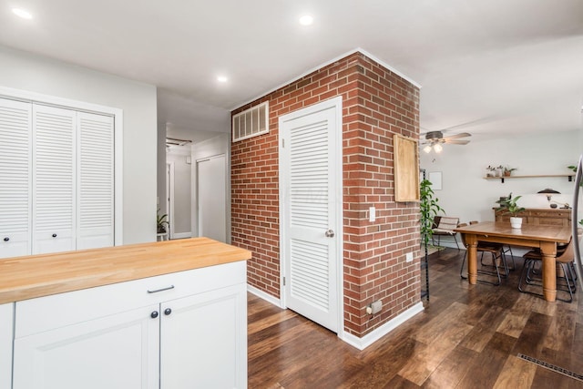 436 Darbyhurst Rd, Columbus, OH 43228 - hall with dark wood-style floors, recessed lighting, and brick wall