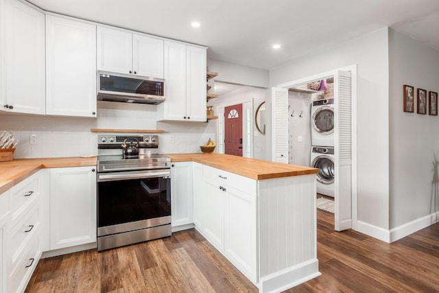 436 Darbyhurst Rd, Columbus, OH 43228 - kitchen featuring butcher block countertops, appliances with stainless steel finishes, stacked washing machine and dryer, a peninsula, and recessed lighting