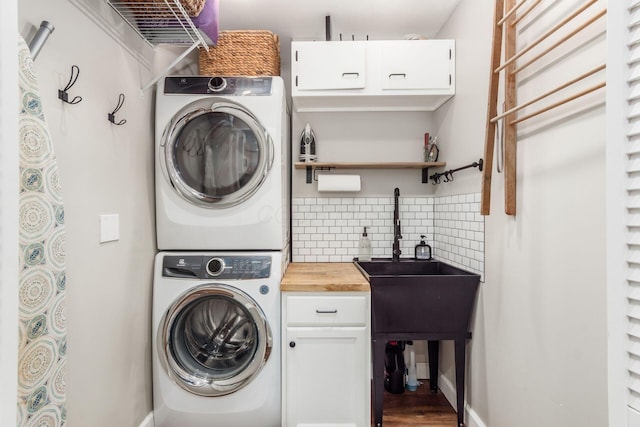 436 Darbyhurst Rd, Columbus, OH 43228 - laundry area with stacked washer / dryer, cabinet space, and wood finished floors