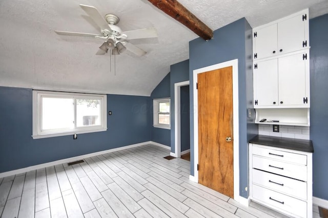 7579 Rangeline Rd, Mount Vernon, OH 43050 - additional living space with a textured ceiling, a ceiling fan, and light wood-type flooring